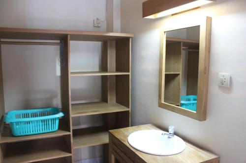 a bathroom with a sink and a mirror at Prambanan Guesthouse in Yogyakarta