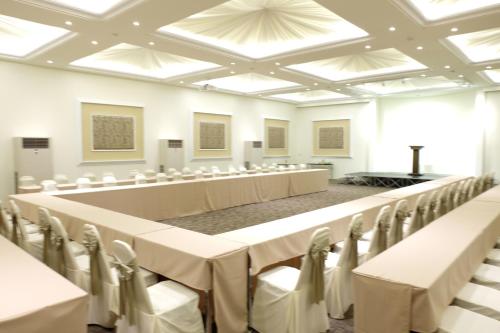 a large room with rows of tables and chairs at Summer Tree Hotel in Bangna