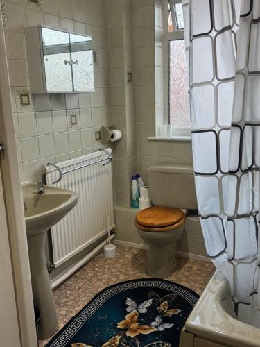 a bathroom with a toilet and a sink and a tub at Komegloba Exquisite room in Manchester