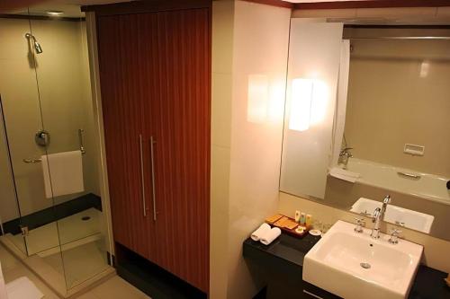 a bathroom with a sink and a mirror at Hotel Pangeran in Pekanbaru