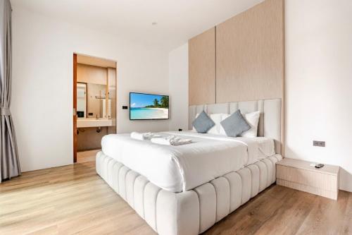 a large white bedroom with a large white bed at 3BR Pool Villa JAAI in Ban Saiyuan (1)
