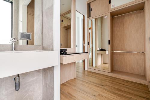two pictures of a bathroom with a sink and a mirror at 3BR Pool Villa JAAI in Ban Saiyuan (1)