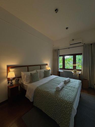 a bedroom with a bed with two towels on it at Luxe Hideaway in Colombo
