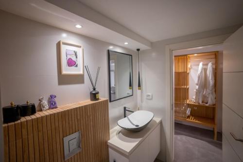 a bathroom with a toilet and a sink in it at Villavender Boutique Suites in Netivot