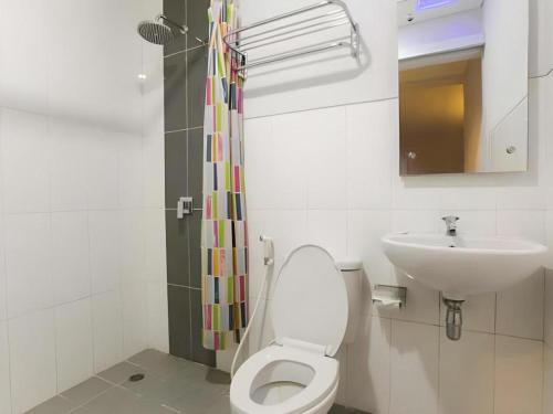 ein Badezimmer mit Toilette und Waschbecken in der Unterkunft Life Puri Hotel Surabaya in Surabaya