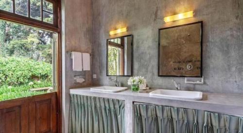 a bathroom with two sinks and a large window at Craigbank Nuwaraeliya in Nuwara Eliya