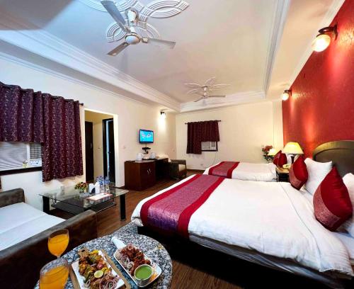a hotel room with two beds and a tray of food at Airport Hotel Port View,Complimentary Airport Pickup or Drop in New Delhi