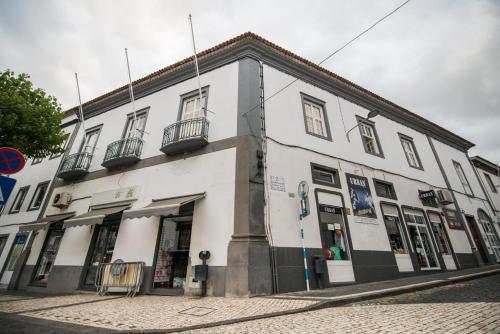 a white building on the side of a street at GuestReady - O Ateneu GuestHouse in Ponta Delgada