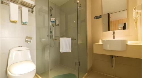 a bathroom with a shower and a toilet and a sink at City Comfort Inn Yongzhou Jinshuiwan in Guzhuting