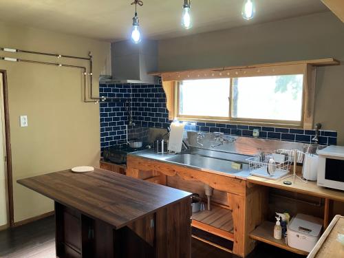 a kitchen with a sink and a counter top at Toma House in Tōma