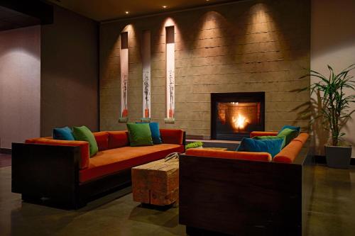 a living room with two couches and a fireplace at Hyatt House Seattle/Redmond in Redmond