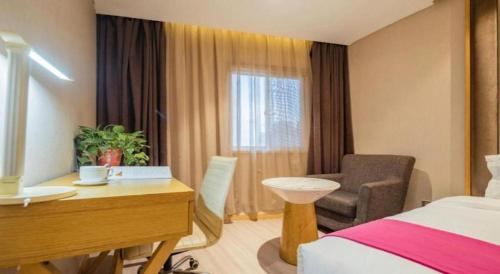 um quarto de hotel com uma cama, uma escrivaninha e uma cadeira em Xian Leica Hotel em Xian