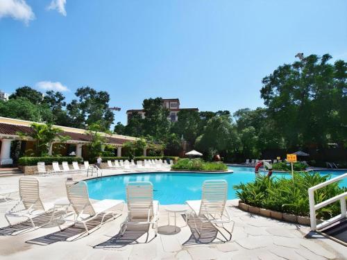a group of chairs sitting around a swimming pool at Regency Art Hotel in Macau