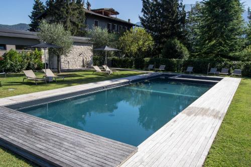 a swimming pool in the yard of a house at Verdepiano Bed & Camping in Riva del Garda
