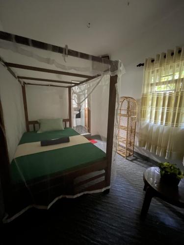 a bedroom with a bunk bed in a room at Praba villa in Midigama East