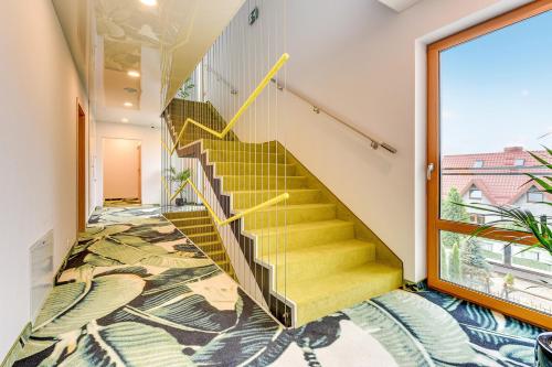 a staircase in a house with a mural on the floor at Baltic Sands in Hel
