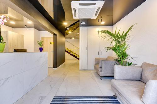 a living room with a couch and a staircase at Baltic Sands in Hel