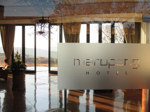 a sign in the lobby of a hotel at Maropeng Boutique Hotel in Magaliesburg