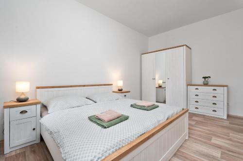 a bedroom with a bed with two towels on it at Apartmán U Dubu in Jablonné nad Orlicí