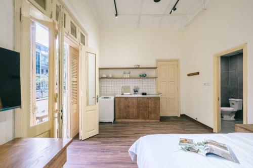 a bedroom with a bed and a bathroom with a sink at Glass Apartment With Big Balcony in Hanoi