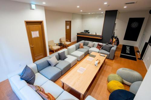 a living room with a couch and a table at オトヤド in Matsuyama