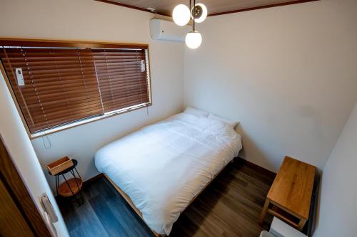 Ένα ή περισσότερα κρεβάτια σε δωμάτιο στο オトヤド