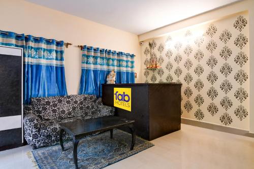 a living room with a couch and a table at FabHotel Samanta in kolkata