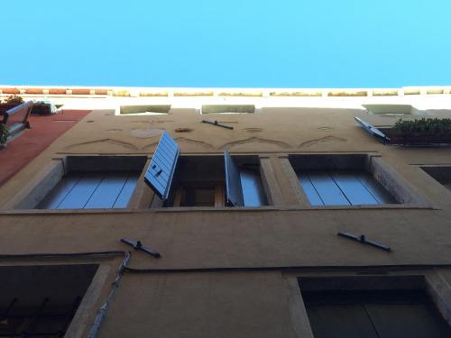 a building with four windows with a sign on it at Polo's Treasures in Venice
