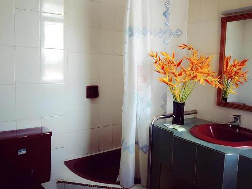 a bathroom with a sink and a shower curtain at Global Hotel Labuan in Victoria Town