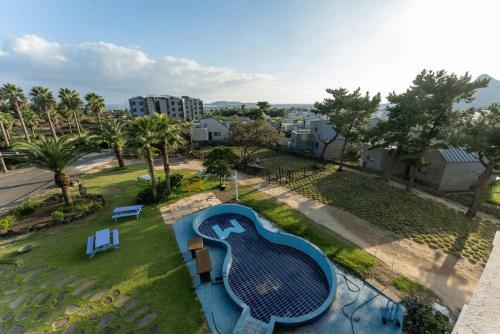 an aerial view of a swimming pool in a park at Jeju Daonjae Sagye Branch in Seogwipo