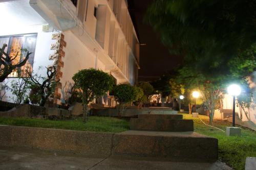 a group of stairs next to a building at night at Hill View Hotel McCarthy Hills in Bortianor