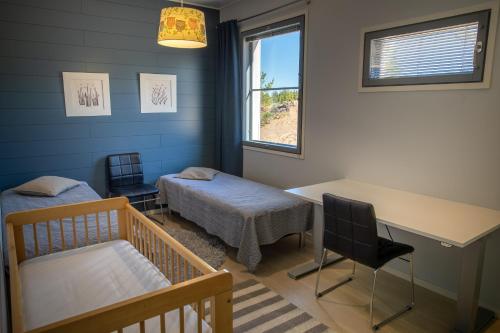 una camera da letto con un letto, una scrivania e un tavolo di Aurinkorinne 10 a Kalajoki