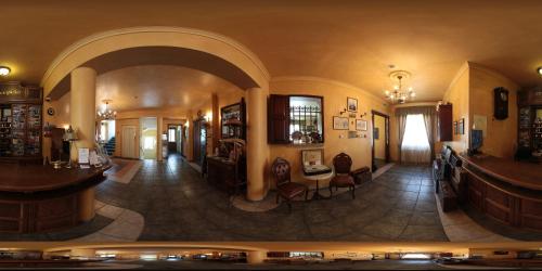 a view of a room with a lobby with chairs and tables at Lévay Villa Hotel in Miskolc