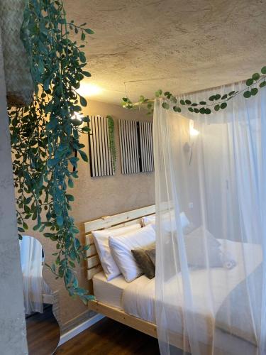 a bedroom with a bed with a white canopy at Boho B&B in Amnon