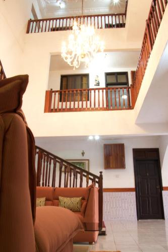 a living room with a couch and a staircase at Hill View Hotel McCarthy Hills in Bortianor