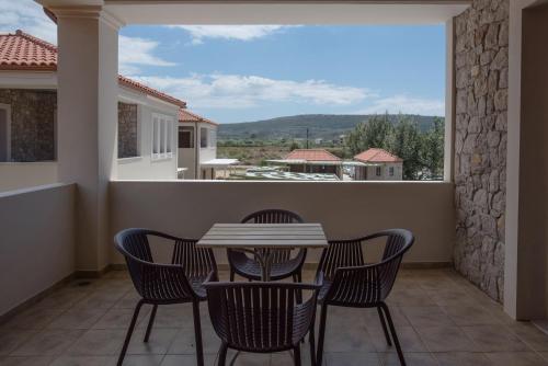 a table and chairs on a balcony with a view at Imathoessa in Gialova
