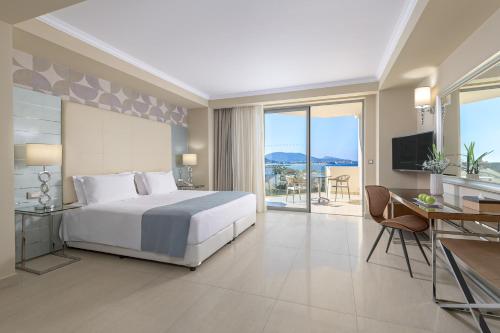 a bedroom with a bed and a desk and a television at Atrium Platinum Resort & Spa in Ixia