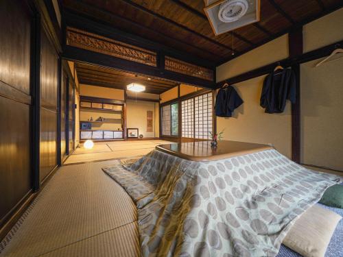 ein Schlafzimmer mit einem Bett in einem Zimmer in der Unterkunft 信州の古民家宿 真秀ろばmahoroba in Nagano