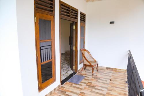 a chair sitting on the porch of a house at Chatu villa in Ahangama