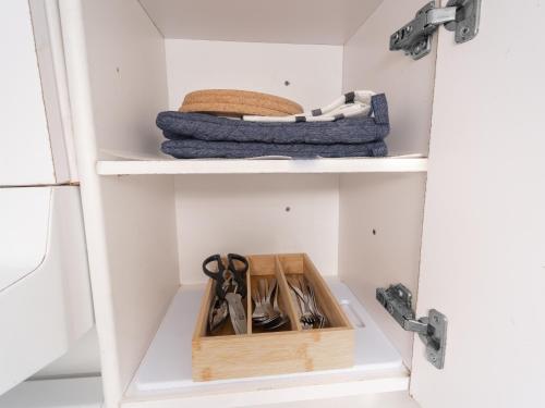 a drawer with scissors and other utensils in it at Cozy Private 2 bedroom apartment, free Wifi, free parking in heart of Toronto, surrounded by nature in Toronto