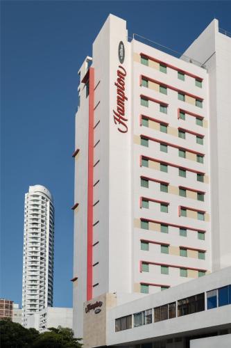 a hotel building with a sign on the side of it at Hampton by Hilton Cartagena in Cartagena de Indias