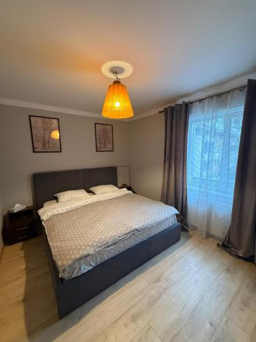 a bedroom with a bed and a light at Apartament 2 camere ultracentral in Craiova