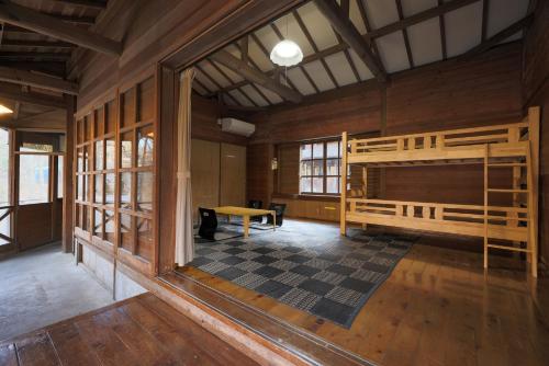 a room with a bunk bed and a table at 秋保木の家ロッジ村 in Sendai