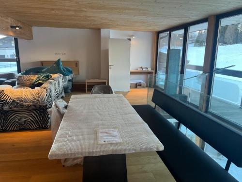a living room with a table and a couch at Panorama Quartier Seefeld in Seefeld in Tirol