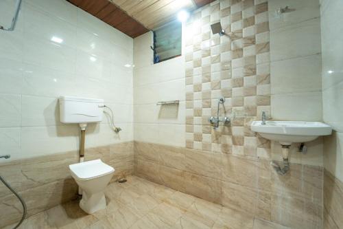 a bathroom with a toilet and a sink at Strawberry County in Panchgani