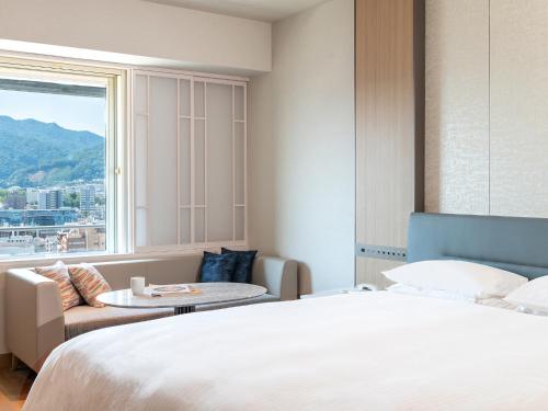 a hotel room with a bed and a window at Kobe Marriott Hotel in Kobe