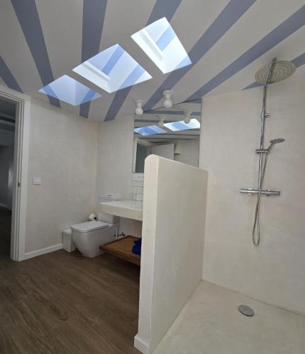 a bathroom with a shower and a sink and a toilet at Bungalows Villas Blancas in Puerto del Carmen