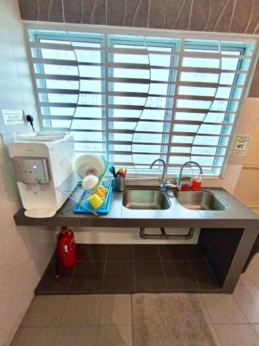 a kitchen counter with a sink and a window at Animation Homes I Meru Raya IPOH I by Grab A Stay l 16pax max in Ipoh