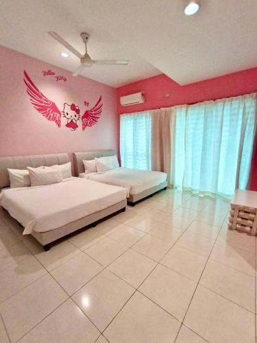 two beds in a bedroom with wings on the wall at Animation Homes I Meru Raya IPOH I by Grab A Stay l 16pax max in Ipoh