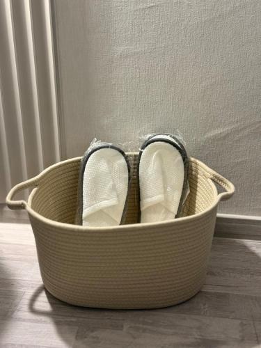 a pair of shoes sitting in a basket on the floor at T&H center Sliven in Sliven
